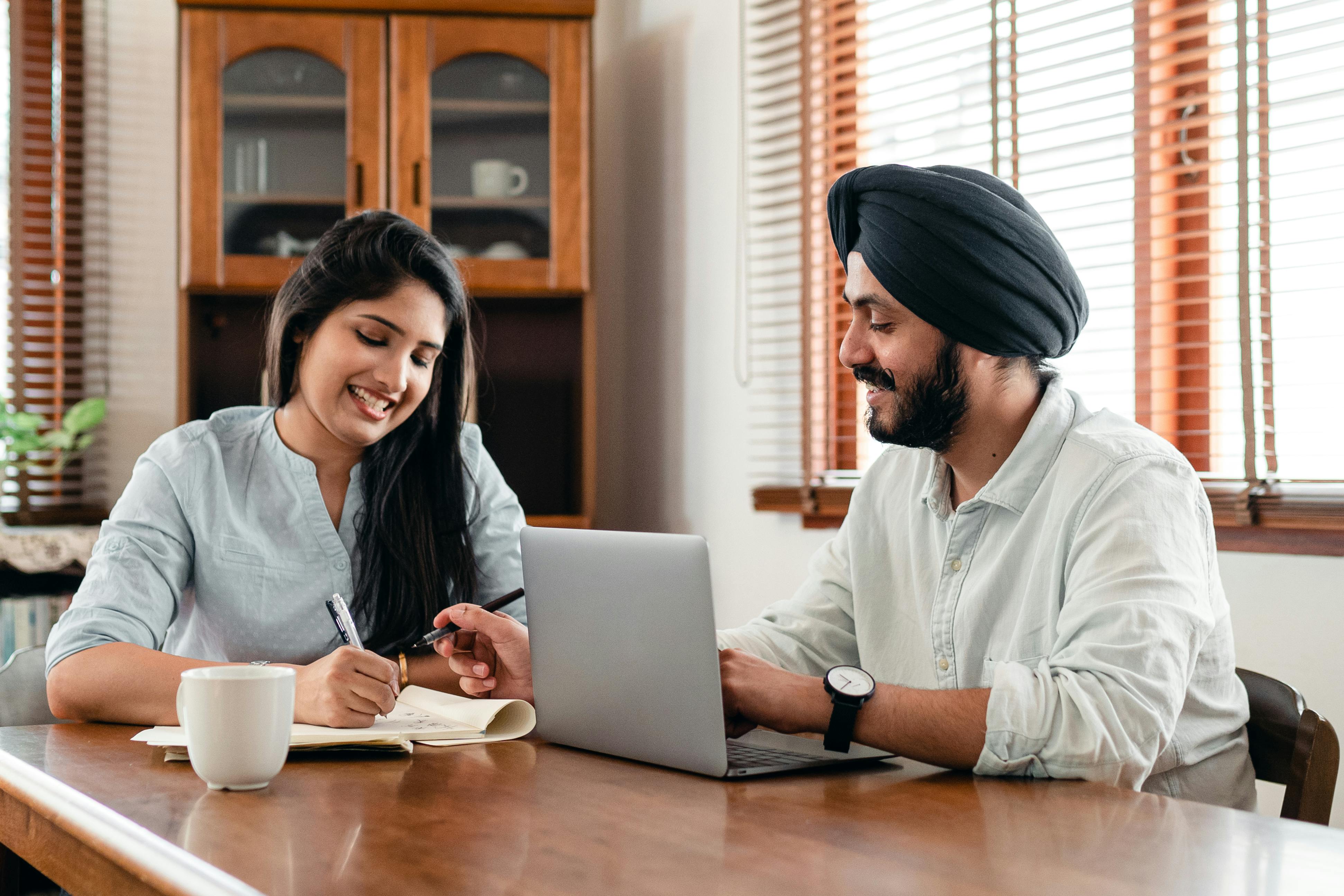Professionals collaborating over a laptop during a recruitment planning session
