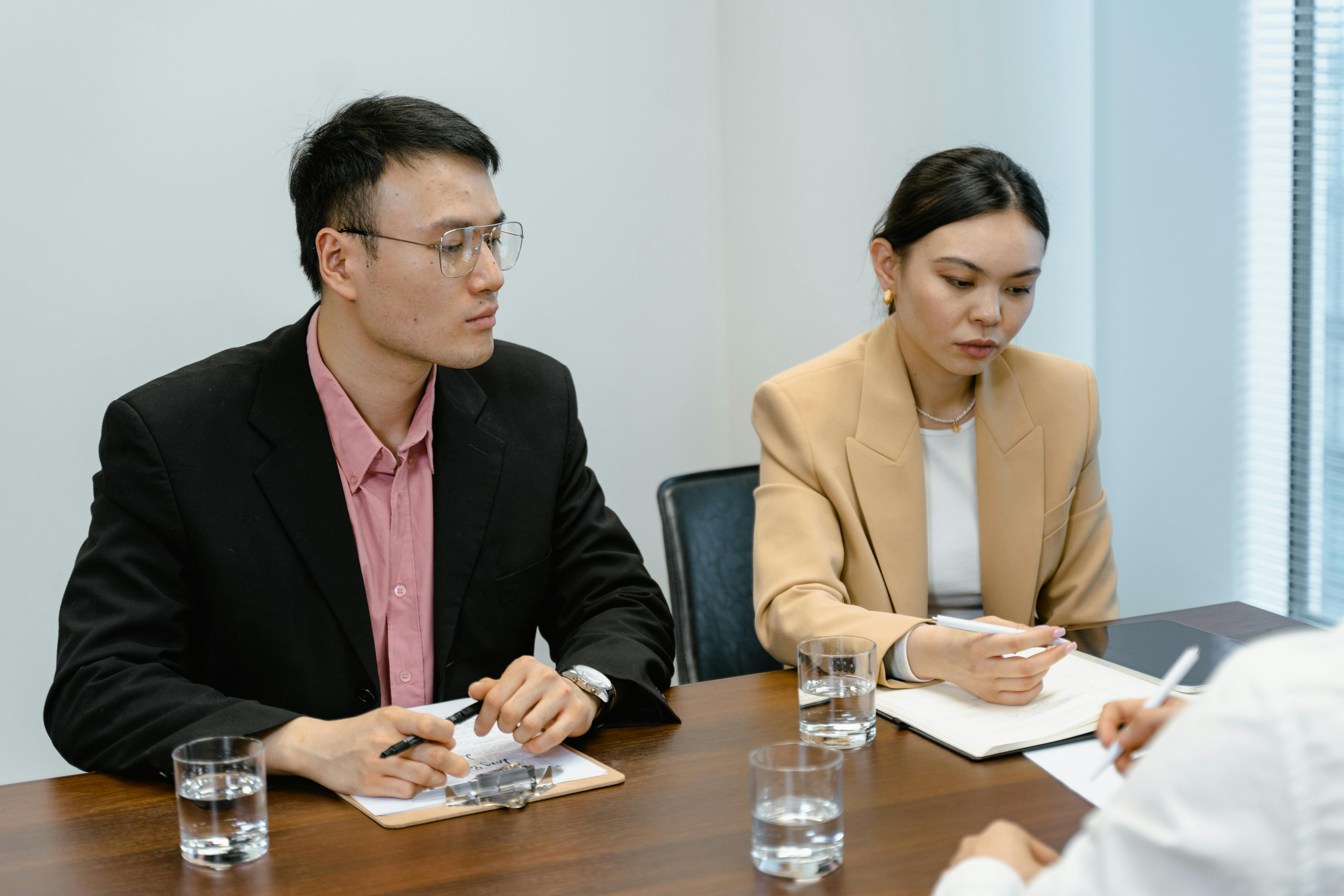 Business meeting panel reviewing notes in a professional office setting